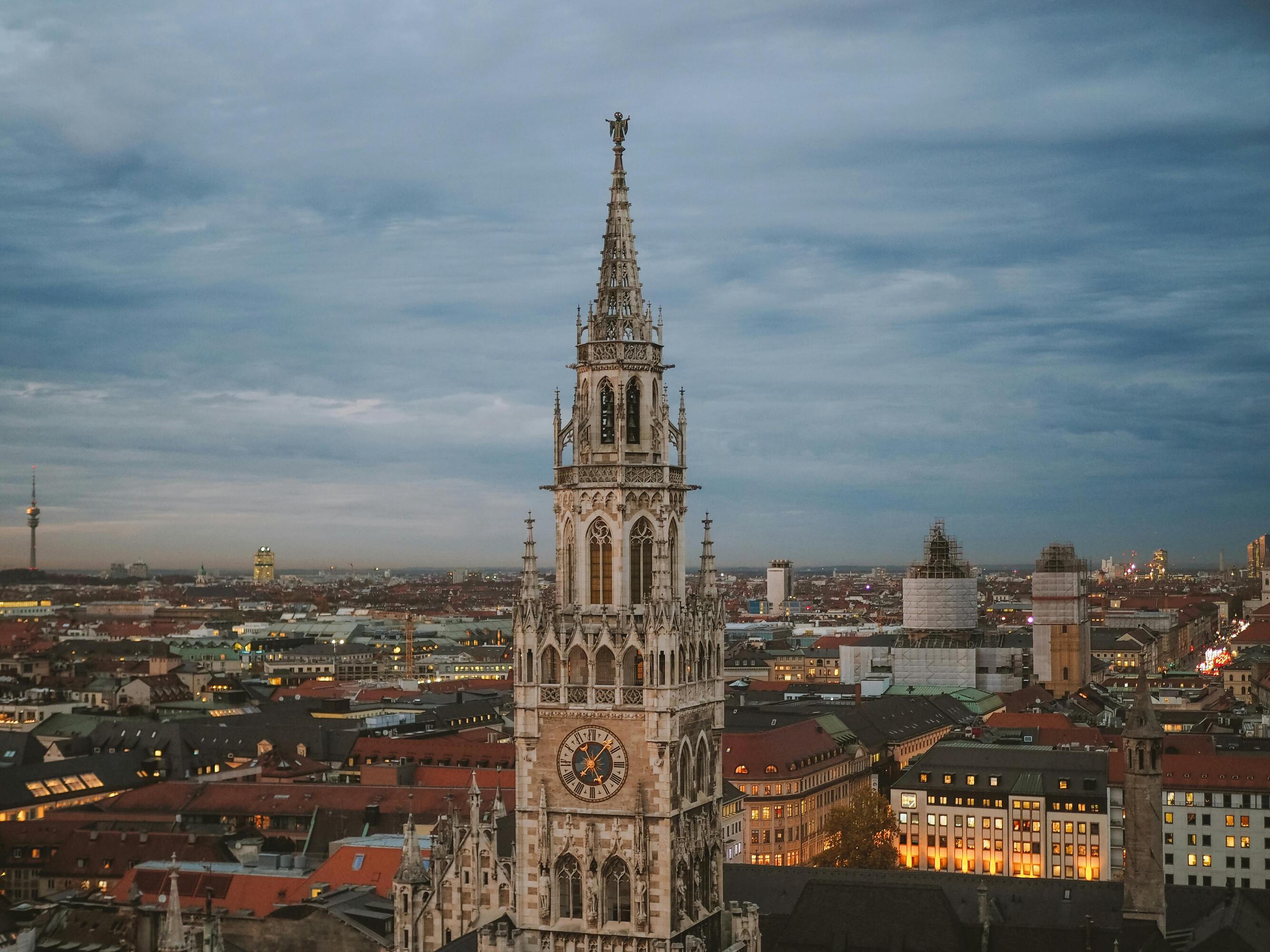A drone shot of Munich City Hall with the city and the Olympic Tower in the background.